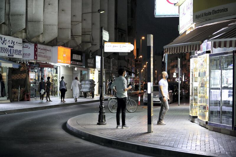 DUBAI, UNITED ARAB EMIRATES , April 27 – 2020 :- People walking on the streets in Al Ras area in Deira Dubai. Authorities ease the restriction for the residents after almost a month long locked down of Al Ras district. (Pawan Singh / The National) For News/Standalone/Online/Instagram