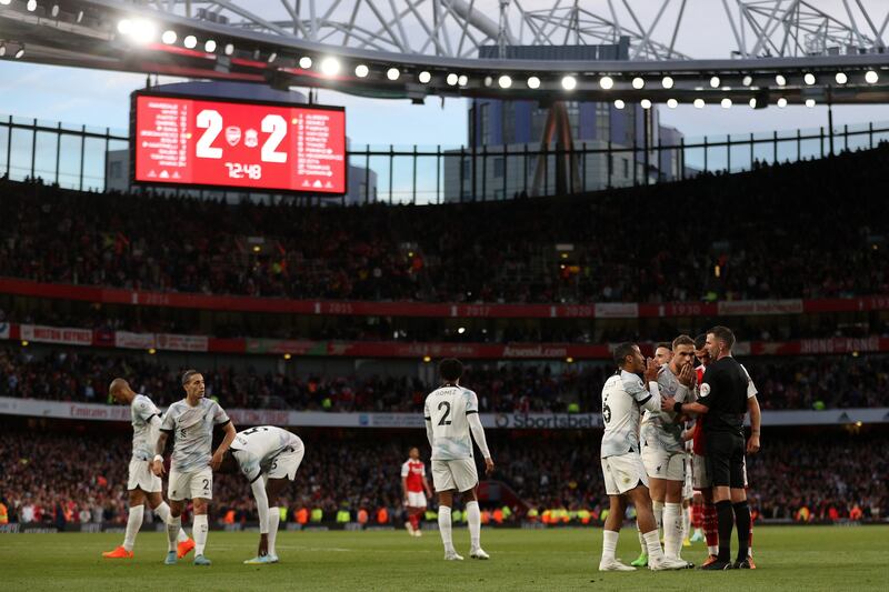 Thiago Alcantara and Jordan Henderson  appeal to referee Michael Oliver after he awarded Arsenal a penalty. AFP