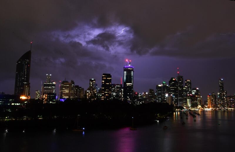 Storm clouds and lightning are seen passing over the Brisbane skyline, from the Kangaroo Point cliffs in Brisbane, Australia. Darren England / EPA.