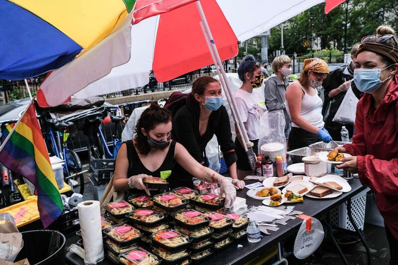 Food is served at a makeshift encampment in City Hall Park in New York City. AFP