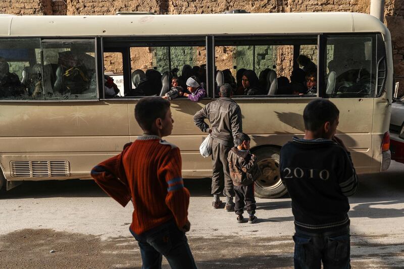 A man talks with his relatives seated inside a bus during the evacuation in rebel-held Douma, Syria, on March 17, 2018. Mohammed Badra / EPA