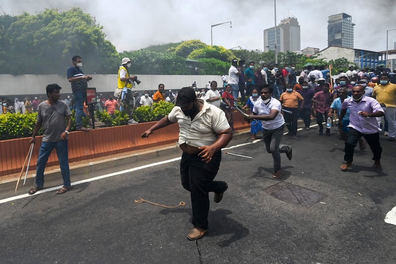 Demonstrators and government supporters clash. AFP