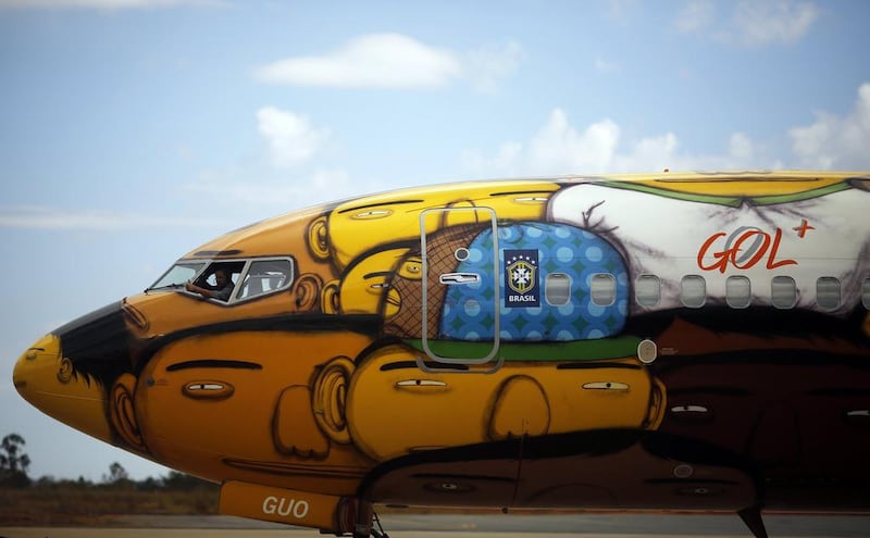 A technician works inside the Boeing 737 aircraft of Brazilian airline Gol, which will travel with the Brazilian national football team during the 2014 World Cup. Nacho Doce / Reuters / May 27, 2014