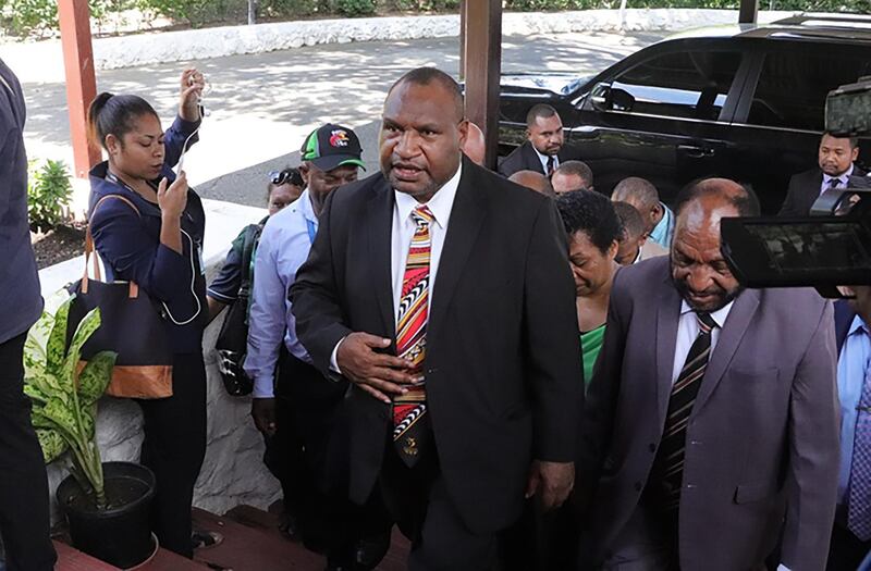 Papua New Guinea's new prime minister, James Marape (C), arrives at the house of Governor-General Bob Dadae to be sworn in as the new leader in Port Moresby on May 30, 2019. - Marape vowed to "tweak" resource laws to give citizens a fairer share on May 30, in a fiery nationalistic address following his election. (Photo by GORETHY KENNETH / AFP)