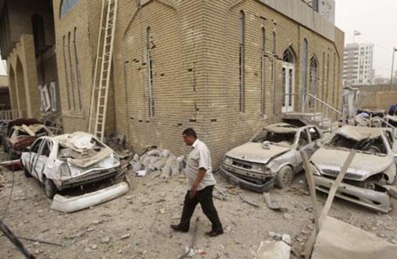 A resident walks past a site destroyed by a bomb attack near the Iranian Embassy in Baghdad on Monday, April 5, 2010.