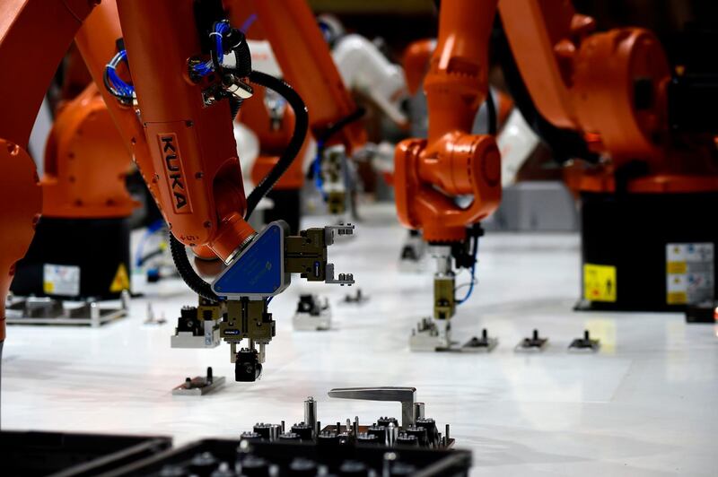Kuka robots are operating at the booth of Schunk during the Hannover Fair on April 23, 2018 in Hanover, Germany.
The Hanover technology fair runs until April 28, 2018, with Mexico as partner country. / AFP PHOTO / Tobias SCHWARZ