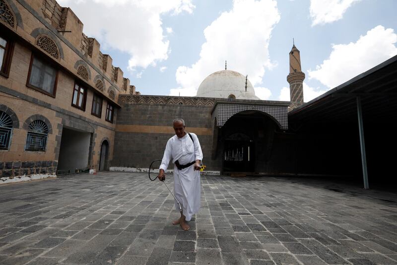 A worker sprays disinfectant inside a mosque in Sanaa, Yemen.  EPA