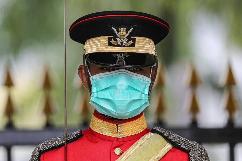 A Malaysian Royal Guard wears a protective mask while he stands guard outside National Palace, following the outbreak of a new coronavirus in China, in Kuala Lumpur, Malaysia. REUTERS