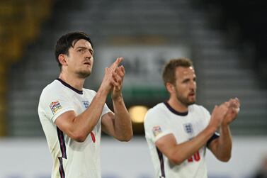 England's defender Harry Maguire (L) an England's striker Harry Kane applaud at the end of the UEFA Nations League, league A group 3 football match between England and Italy at Molineux Stadium in Wolverhampton, central England on June 11, 2022.  (Photo by JUSTIN TALLIS  /  AFP)  /  NOT FOR MARKETING OR ADVERTISING USE  /  RESTRICTED TO EDITORIAL USE