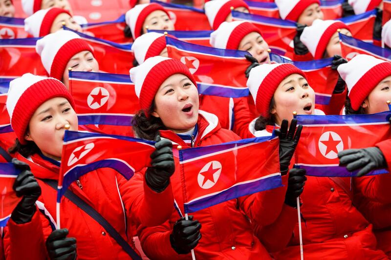 Members of the North Korean delegation wave flags as they wait for the start of the Women's Slalom race at the Yongpyong Alpine Centre during the PyeongChang 2018 Olympic Games, South Korea. The women's slalom race is being cancelled due to weather conditions. Jean-Christophe Bott / EPA