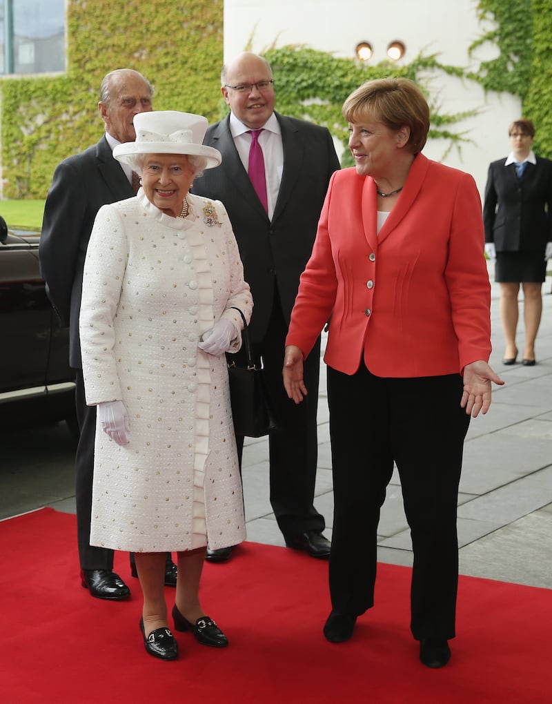 German Chancellor Angela Merkel welcomes Queen Elizabeth II, wearing white, and Prince Philip, Duke of Edinburgh, to the Chancellery in Berlin on June 24, 2015. Getty Images