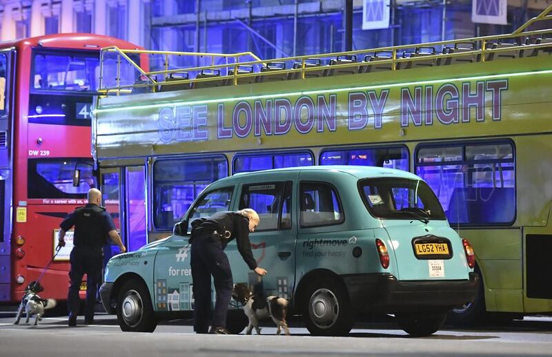 Police sniffer dogs on London Bridge after the incident in central London. Dominic Lipinski / PA via AP