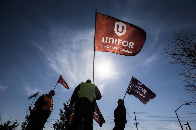 Representatives from Unifor stand outside the Toyota plant in Cambridge. Workers at Toyota’s Canadian plants are set to vote on whether to become the first at wholly owned Toyota facilities in North America to unionise. Mark Blinch / Reuters
