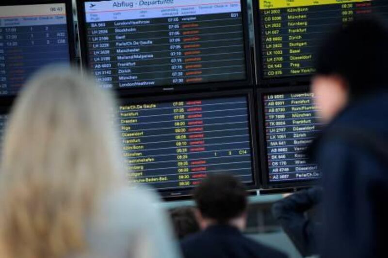 Travellers look at the time board to get informations about their flights on May 25, 2011 at the airport of Hamburg, northern Germany. Ash pouring from an Icelandic volcano reached northern Germany, forcing the closure of airports from Hamburg to Berlin, amid fears European air traffic could soon suffer further disruptions. The cloud is the second in barely a year from an Icelandic volcano to disrupt European air traffic. AFP PHOTO / CHRISTIAN CHARISIUS      GERMANY OUT
 *** Local Caption ***  075809-01-08.jpg