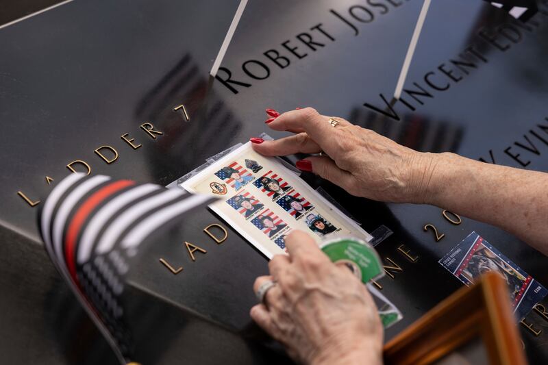 Photos of fallen firefighters are placed on the 9/11 Memorial in New York. AP
