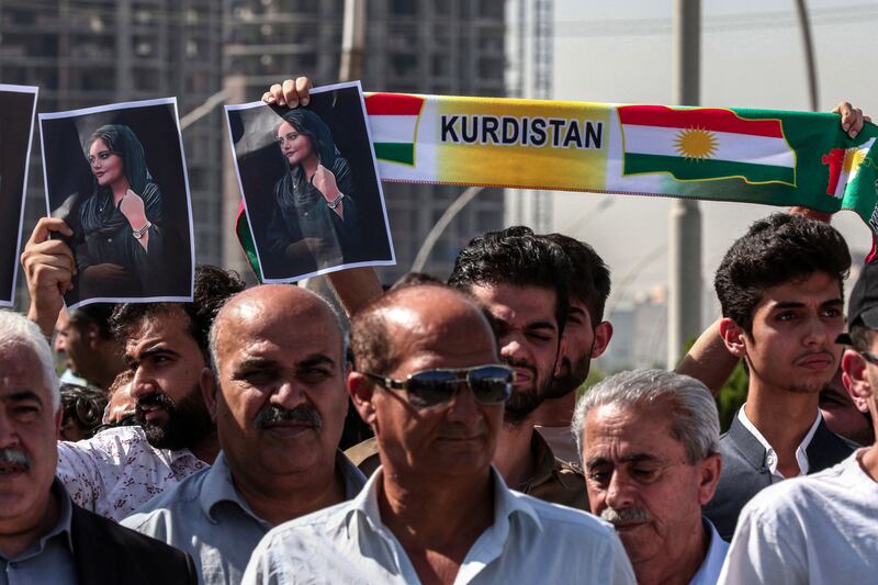 Protesters in Erbil, Iraq, hold up images of Mahsa Amini, an Iranian-Kurdish woman who died in police custody in Tehran. AFP