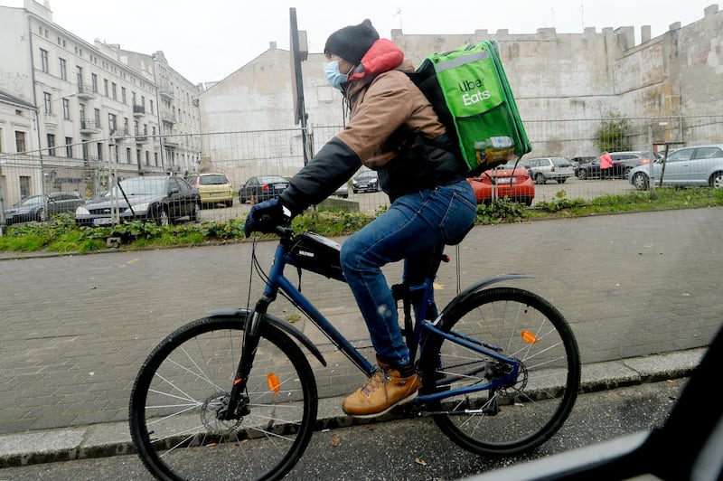 Ruben Limardo Gascon is grateful for the food delivery job in the current economic climate. AP