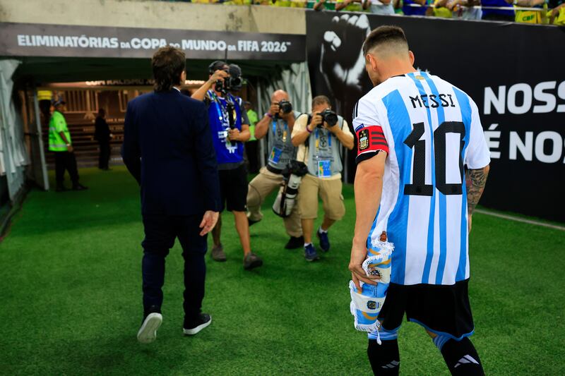 Lionel Messi leaves the pitch as the match was delayed due to incidents in the stands. Getty Images
