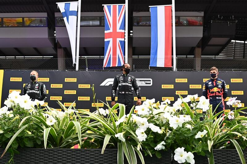 Race winner Lewis Hamilton, centre, alongside Valtteri Bottas, left, and Max Verstappen, who finished third in the Styrian Grand Prix. AFP