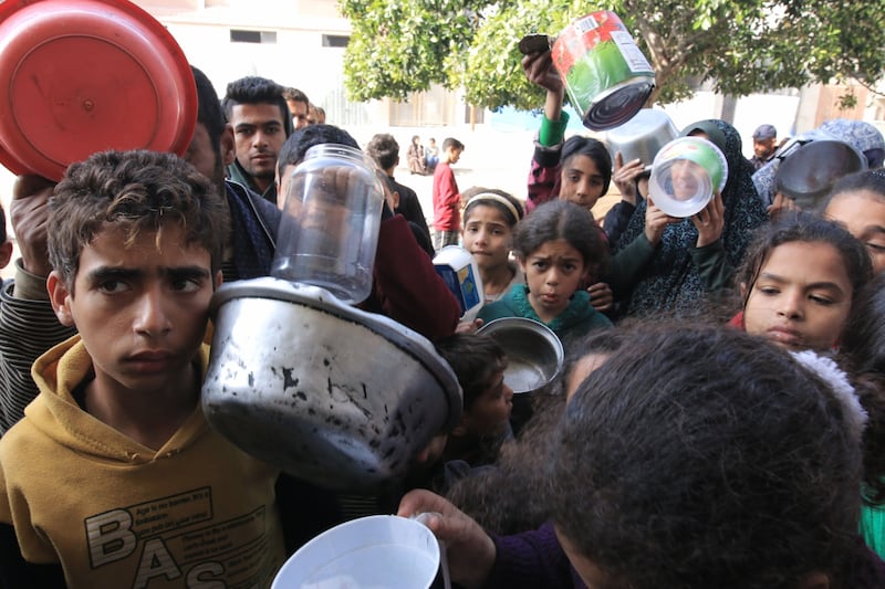 Displaced Palestinians wait to receive free food from a volunteer-run hospice near Nasser Medical Hospital in Khan Younis, southern Gaza, on Tuesday, January 9, 2024. Bloomberg