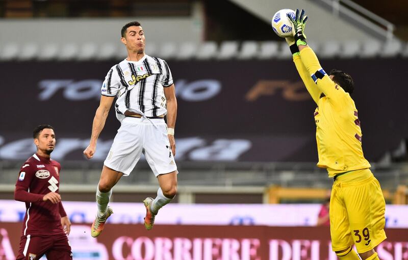 Juventus' Cristiano Ronaldo in action with Torino's Salvatore Sirigu. Reuters