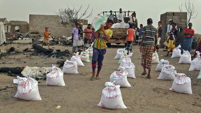 Internally displaced Yemenis receive food aid as Britain promises to give more money and coronavirus vaccines to the war-weary country. AFP