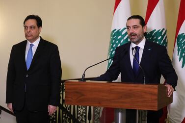 Lebanon's prime minister-designate Saad Hariri speaks as he stands next to caretaker Prime Minister Hassan Diab at the government palace in Beirut on December 11, 2020. Reuters