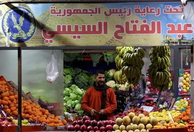 A man stands under a banner that reads: "We are all one, Under the auspices of Egypt's President Abdel Fattah El Sisi", in a popular market in Cairo. Reuters