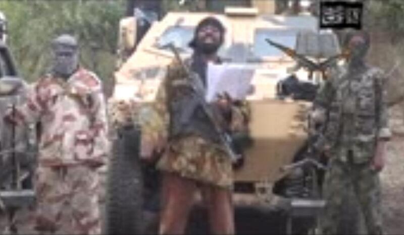 A grab made on May 5, 2014 from a video obtained by AFP shows the leader of the Islamist extremist group Boko Haram Abubakar Shekau, centre, delivering a speech in which he vowed to sell hundreds of schoolgirls kidnapped in northern Nigeria three weeks ago. AFP Photo