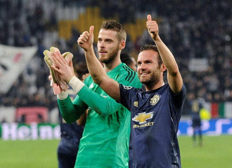 Manchester United players David de Gea and Juan Mata gesture to the crowd after their 2-1 victory over Juventus. AFP