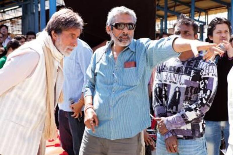 Stills from Bollywood film Aarkshan
 This shows it has the director Prakash Jha (in blue shirt on right) setting out a scene to Indian icon Amitabh Bachchan on the sets of the movie Aakarshan (Reservation). 
In the film  Amitabh Bachchan  plays a college principal


Credit: Courtesy Reliance Entertainment

NOte from the reporter:
Both Mr Jha and Mr Bachchan were recently denied permission to meet students of Lucknow University in northern India where they were scheduled to meet students as part of the film's promotion. The university said this was due to the sensitive nature of the film and the crew has since scheduled meetings with students in other colleges in Lucknow and other cities of India to promote more understanding about the movie. 
