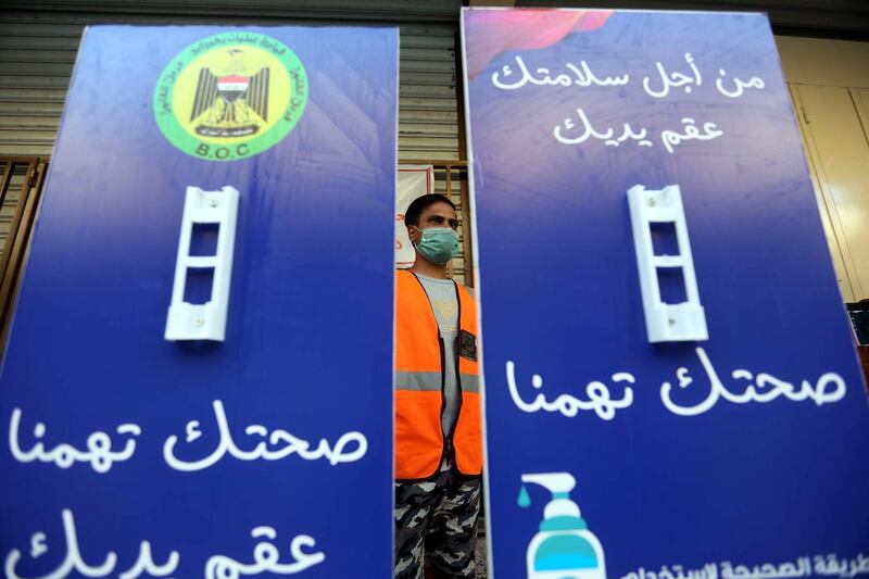 An Iraqi works on Informative signs with coronavirus guidelines reading in Arabic "Your health is important to us, sterility of your hand" at a local printing house in Baghdad. EPA