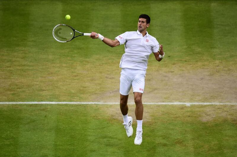 Novak Djokovic returns against Jo-Wilfried Tsonga in his fourth-round victory at the 2014 Wimbledon Championships on Monday at the All England Club in London, England. Carl Court / AFP