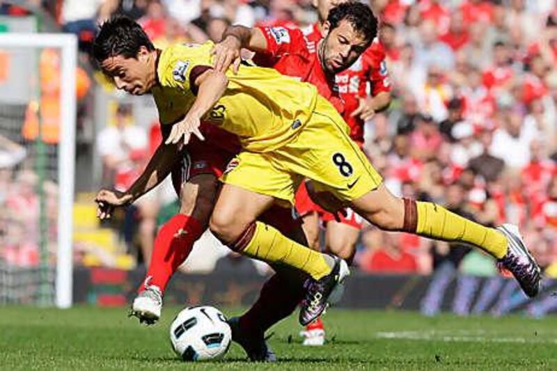 Javier Mascherano, back, tackles Arsenal's Samir Nasri.