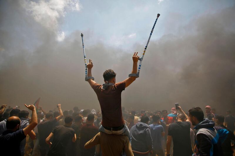 Palestinians protest against the inauguration of the US embassy in  Jerusalem, as they protest near the border between Israel and the Gaza Strip, east of Jabalia. Mohammed Abed  / AFP Photo