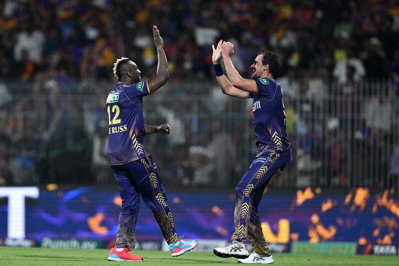 Kolkata Knight Riders' Andre Russell celebrates with teammate Mitchell Starc after taking the wicket of Sunrisers Hyderabad's Aiden Markram. AFP