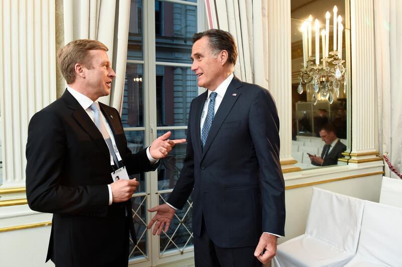 Mitt Romney, right, talks with BMW CEO Oliver Zipse during a meeting on the first day of the Munich Security Conference in Munich, Germany. AP Photo