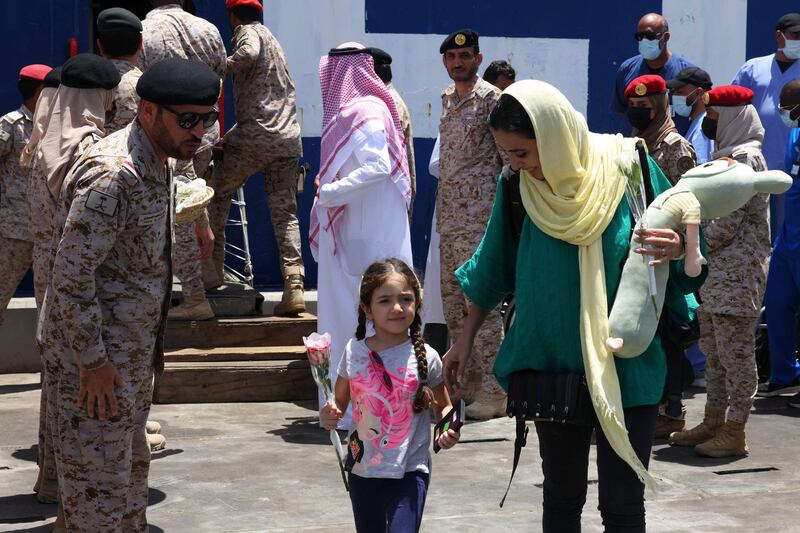 Saudi soldiers welcome people from Sudan as they arrive at the King Faisal Naval Base in Jeddah. AFP