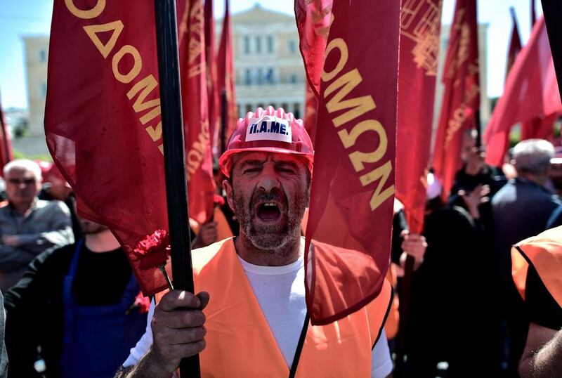 A Greek protester shouts slogans during a demonstration marking May Day in Athens. Aris Messinis / AFP Photo