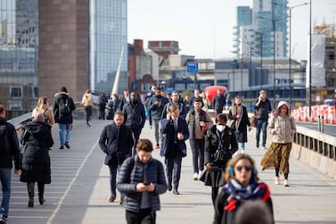 Commuters walk along London Bridge in the UK. The number of people in employment jump by 84,000 in the first quarter of 2021, the first increase since the coronavirus crisis began, while those classed as unemployed fell by 121,000. Getty Images