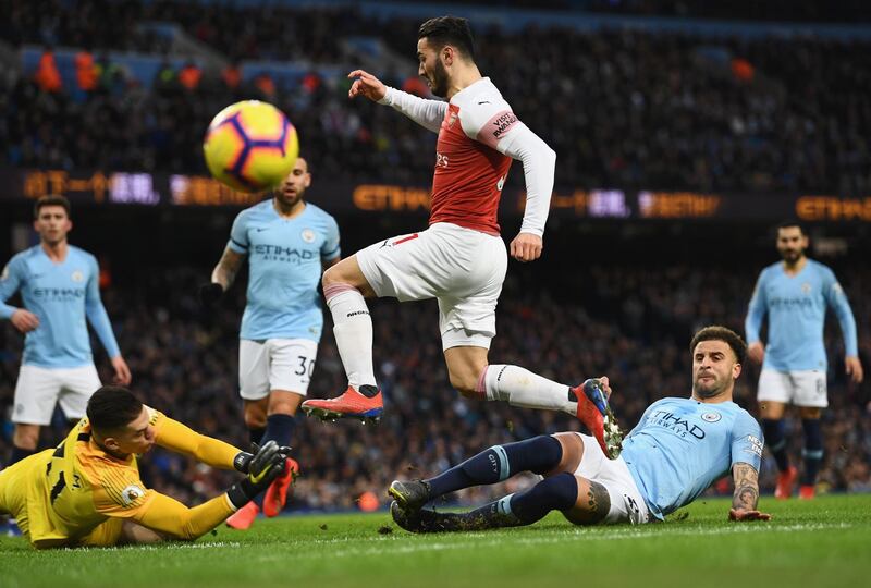 Sead Kolasinac of Arsenal is foiled by Kyle Walker and Ederson of Manchester City. Getty Images