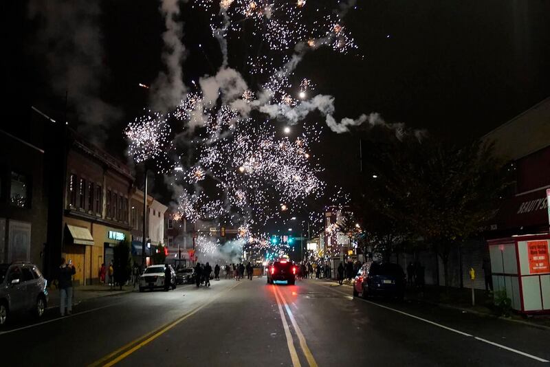 Fireworks explode in the sky during a protest in response to the police shooting of Walter Wallace Jr. in Philadelphia.  AP