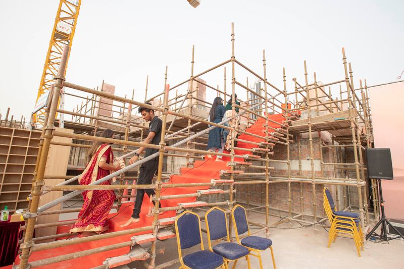 People arrive at the prayer ceremony to mark the construction milestone. 