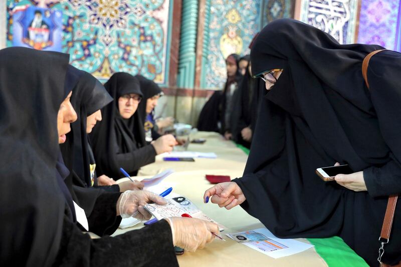 A voter registers to cast her vote during the parliamentary elections at a polling station in Tehran, Iran. Iranians began voting for a new parliament on Friday, with turnout seen as a key measure of support for Iran's leadership as sanctions weigh on the economy and isolate the country diplomatically. AP