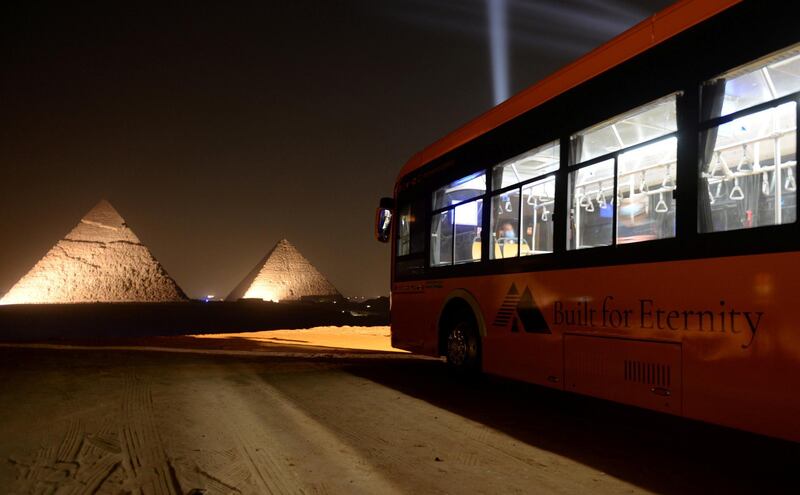 An electrical bus for visitors is seen front of the Great Pyramids during the opening of a new restaurant called 9 Pyramids Lounge. Reuters