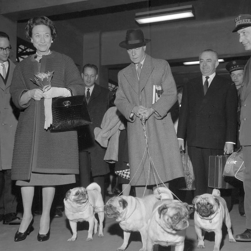 Edward, Duke of Windsor, and his wife the Duchess Wallis of Windsor, arrive with their dogs at Saint-Lazare train station in Paris, 02 May 1960, after having spend the winter in the United States. Edward VIII of England, eldest son of George V and Mary of Teck, abdicated because of his love affair with American-born divorcee Wallis Simpson. After his abdication, he became Duke of Windsor and married Mrs. Simpson, who had changed her name by deed poll to Wallis Warfield, in a private ceremony on 3 June 1937 at Chateau de Candé, Monts, France. (Photo by - / AFP)