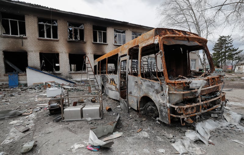 Debris of a school bus near a damaged school that was a base for Russian troops in Bohdanivka, Ukraine. EPA