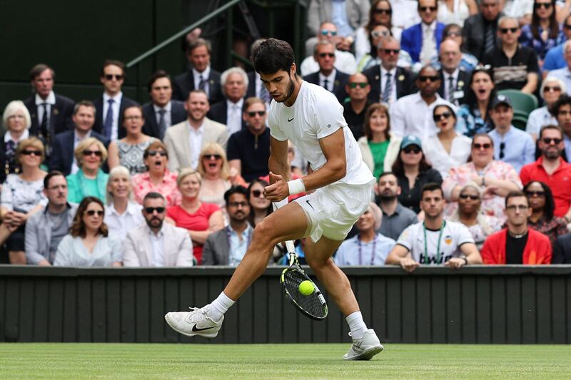 Carlos Alcaraz returns the ball through his legs. AFP