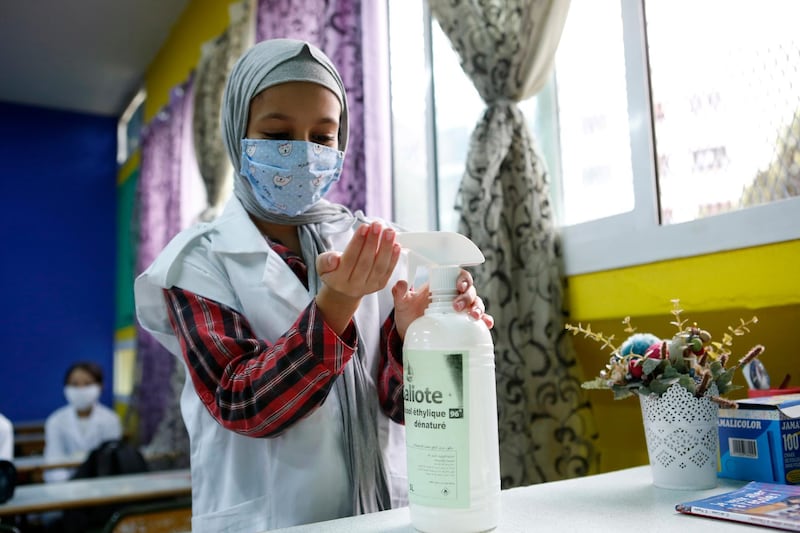 Student Imane Date disinfects his hands in his classroom at Mansour Eddahbi college in the Derb El Kabir district of the AL Fida prefecture in Casablanca, Morocco. Today it is the start of the school year in Casablanca, with a delayed start due to the COVID-19 pandemic. AP Photo