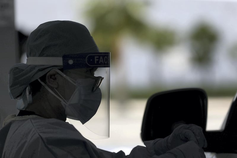 Dubai, United Arab Emirates - Reporter: Patrick Ryan. News. Covid-19/Coronavirus. A health worker wears PPE as people go to be tested at the City Walk screening centre in Dubai. Thursday, July 2nd, 2020. Dubai. Chris Whiteoak / The National